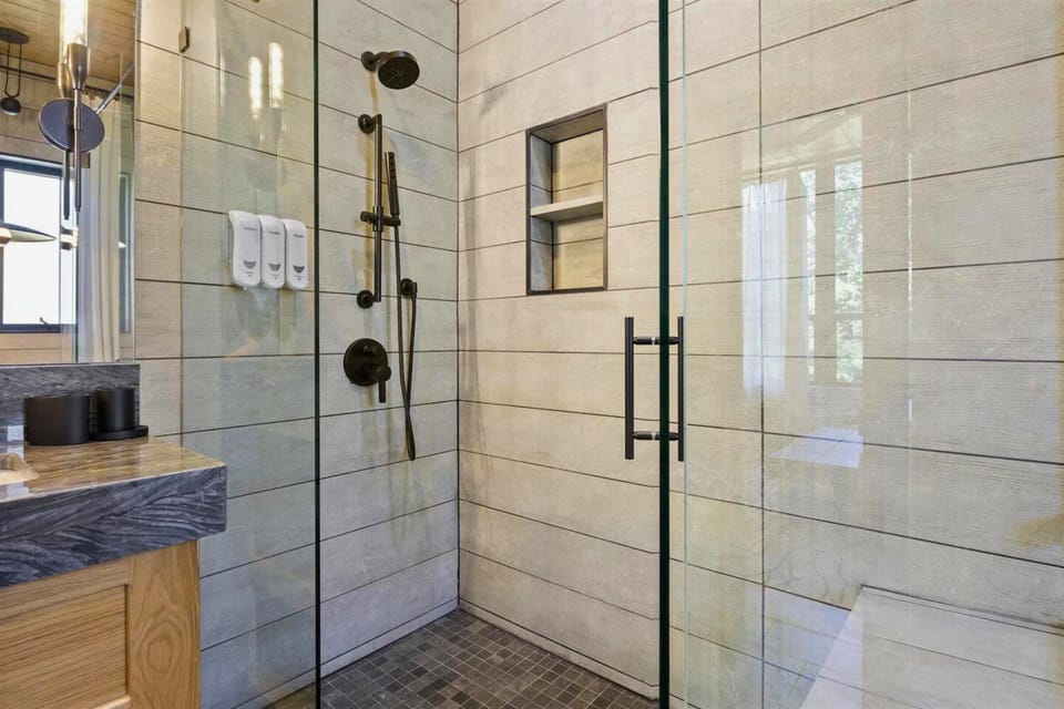 Modern meets rustic in this sleek shower space — the perfect place to rejuvenate after exploring the great outdoors.