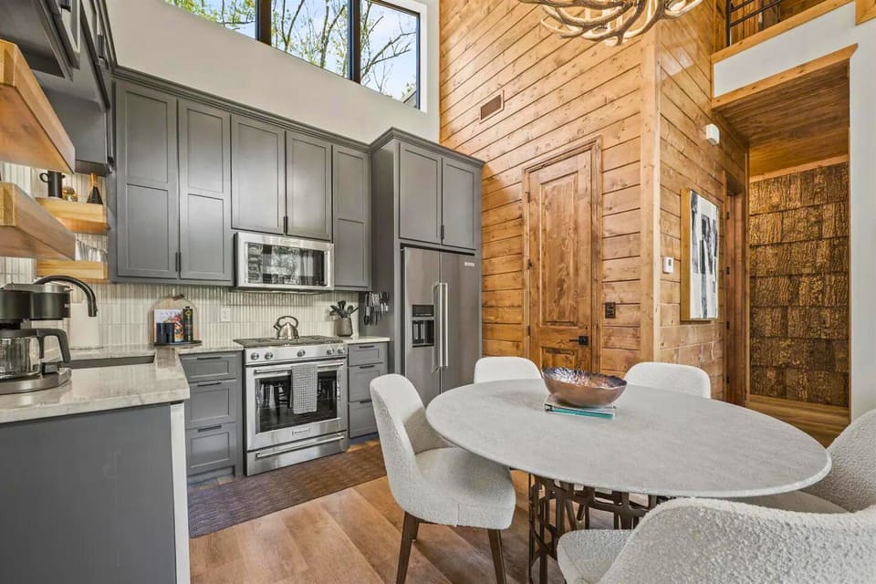 Cozy up in our cabin's kitchen, where modern amenities meet rustic charm. Start your day with a coffee surrounded by the warmth of natural wood!