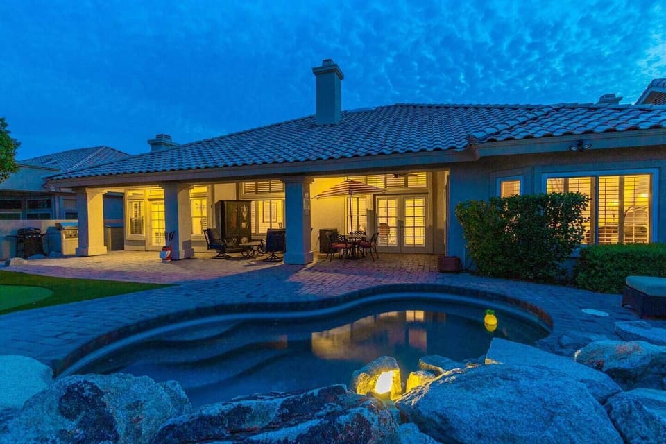 Backyard with small pool, putting green and misters to keep you cool in the heat.  