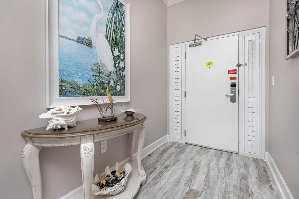 Step into a welcoming entrance where coastal art invites you to begin your beach getaway with loved ones