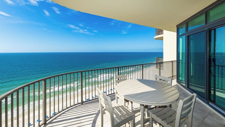 Your balcony invites morning coffee with the gentle sound of waves rolling onto the coast below