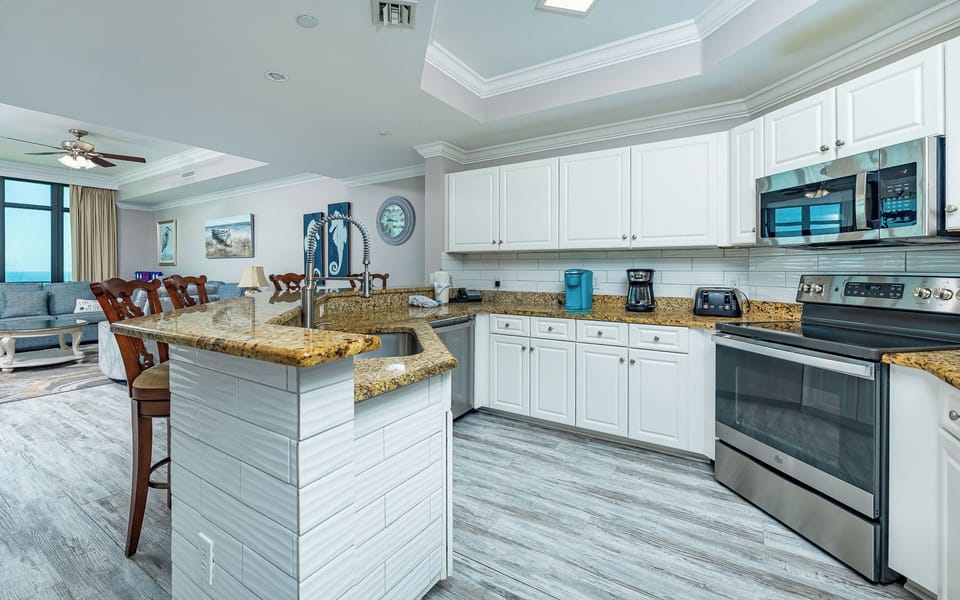 The kitchen's granite breakfast bar surrounds you with warmth as you prepare snacks for your family fun day