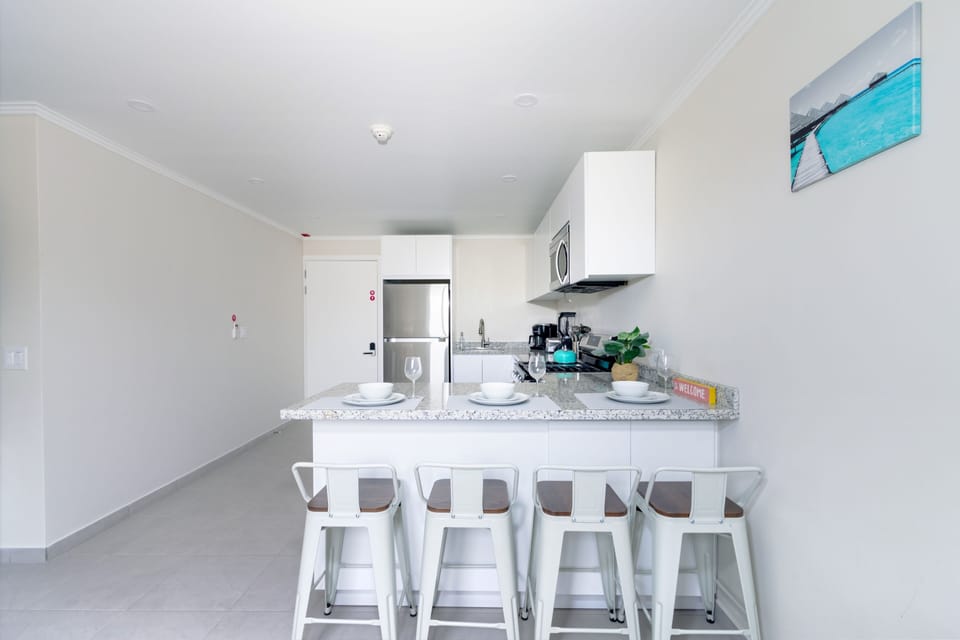 Modern Kitchen of the 2-BR Condo in Noord Aruba - Well-lit space with strategically placed task lighting - Elegant and coordinated color palette for a cohesive look - Fully Equipped