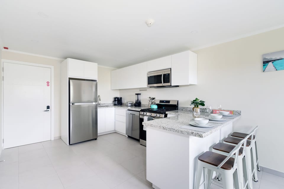 Gorgeous Kitchen of the 2-BR Condo in Noord Aruba - Smart use of space with versatile storage solutions - Open concept connecting the kitchen to the dining or living area - Thoughtful placement of kitchen essentials for easy access - Meal Bar