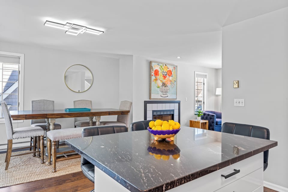 Bright open-concept layout connects the dining area, living room, and kitchen