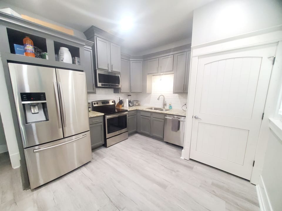 The kitchen has full size refrigerator also a stove, oven, microwave, dishwasher