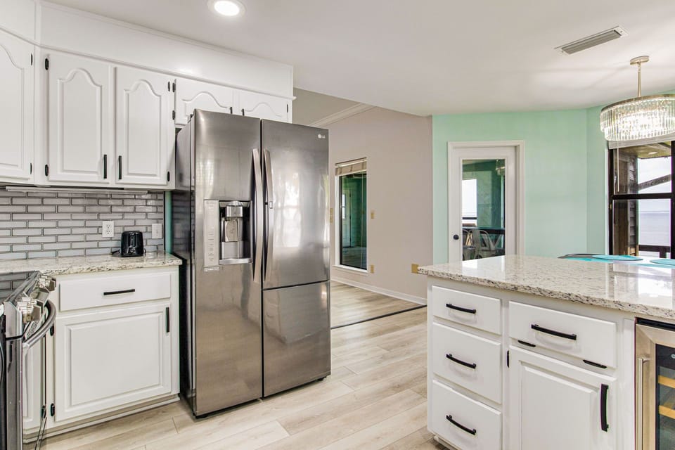 Kitchen with subway tile backsplash and stainless appliances Gulf Breeze bayfront vacation rental home