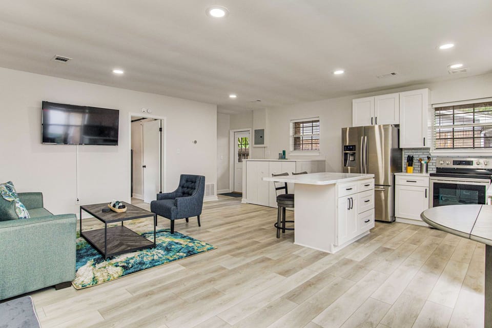 Open-concept living room with bay views at Gulf Breeze waterfront house near Pensacola