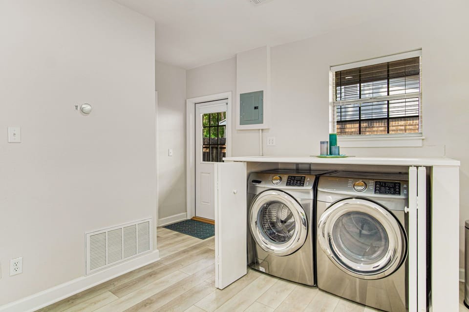 Dedicated laundry area with full-size washer and dryer at Bayfront Gulf Breeze pet-friendly vacation house