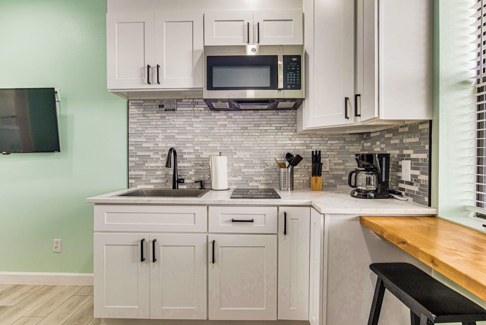 Stocked kitchenette with microwave and coffee maker with Bayfront views