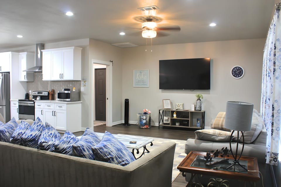 Large, open living room with sofa bed against windows