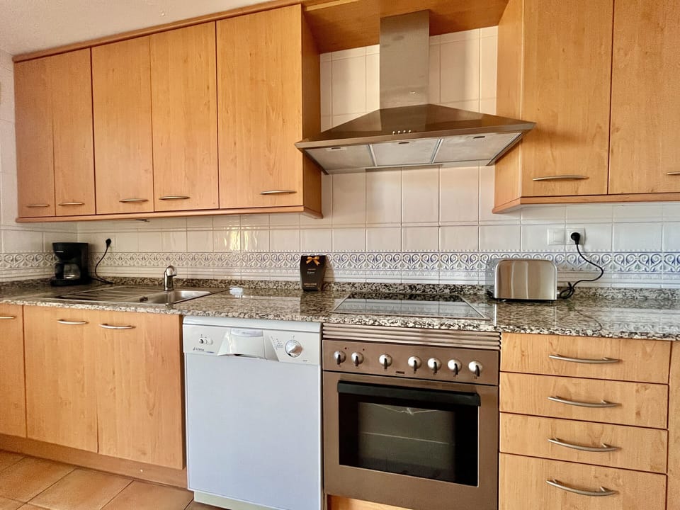 "Our fully equipped kitchen is a paradise for cooking lovers. It has an oven, microwave, ceramic hob and refrigerator for all your culinary needs. In addition, you will find a coffee maker to enjoy a fresh coffee, a toaster for breakfast and a kettle for your infusions. You will not want for anything, as we have also included all the necessary utensils to cook any dish you fancy."