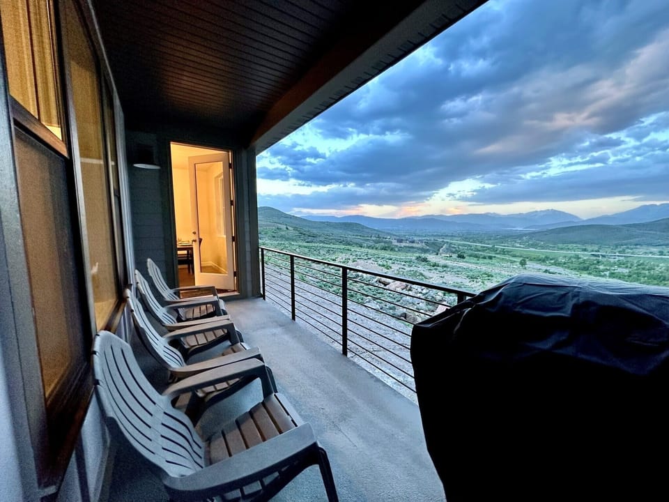 Back deck with propane grill and adirondak chairs for enjoying the views