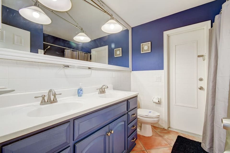 This bathroom has it all: sleek design, plenty of storage, and a luxurious shower to melt your stress away.