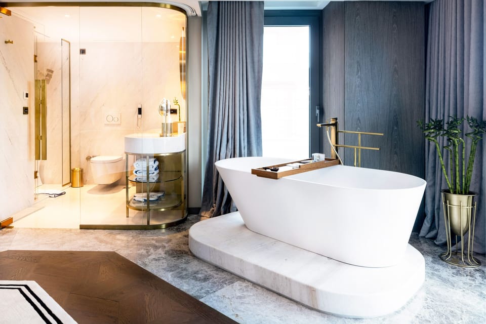 Deep soaking tub, hydromassage showerhead, designer toiletries