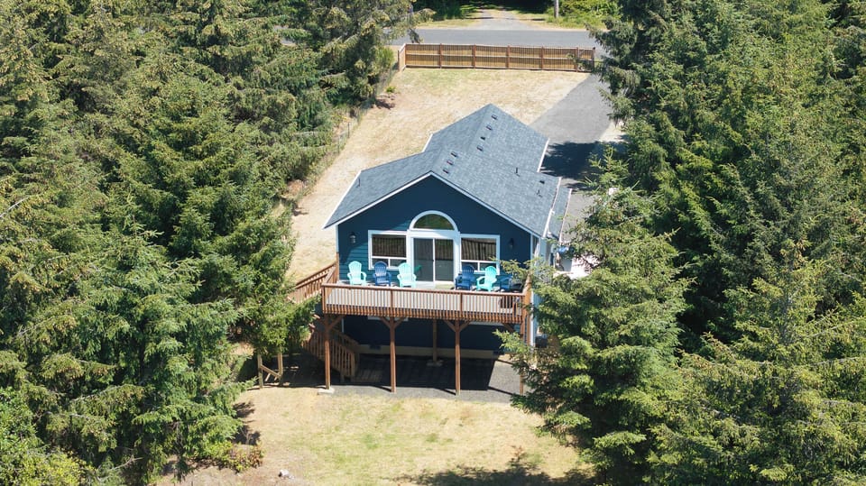 Deck with grill and adirondack chairs  