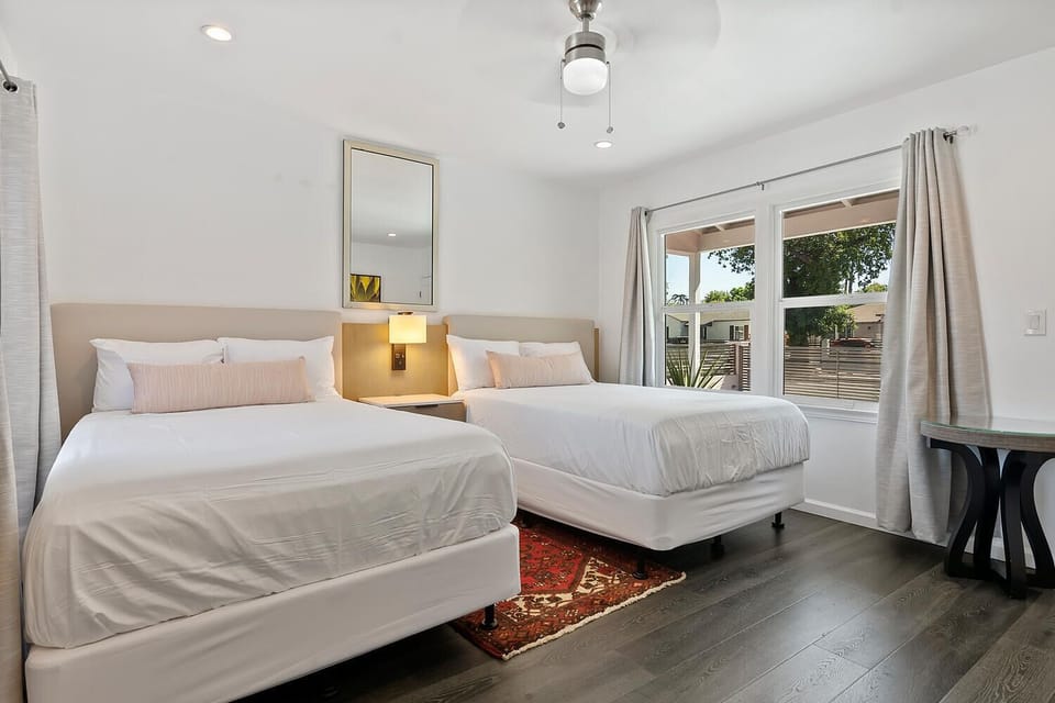 Bright bedroom with two full-size beds