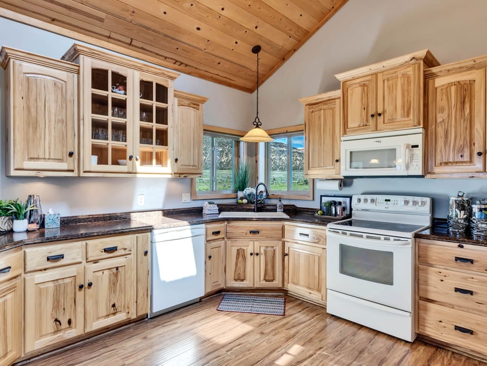 Kitchen: Charm and function unite in this sunlit space with stunning mountain views!