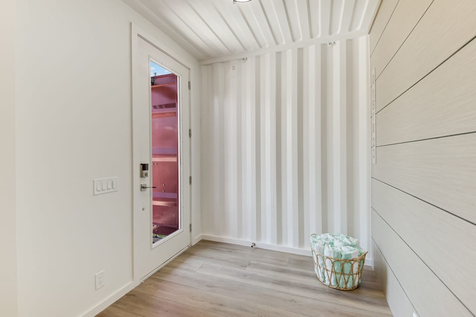 Step into your private sauna retreat with infrared lighting, where warm wooden walls and thoughtful amenities await your relaxing escape.