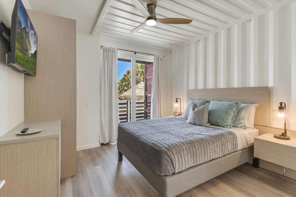 Drift into peaceful sleep in your serene bedroom, where tropical breezes flow through and soft linens invite ultimate relaxation.