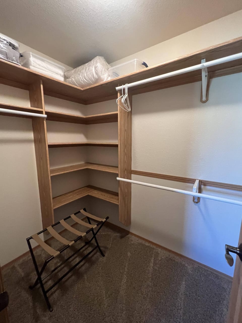 Walk-in closet in queen bedroom