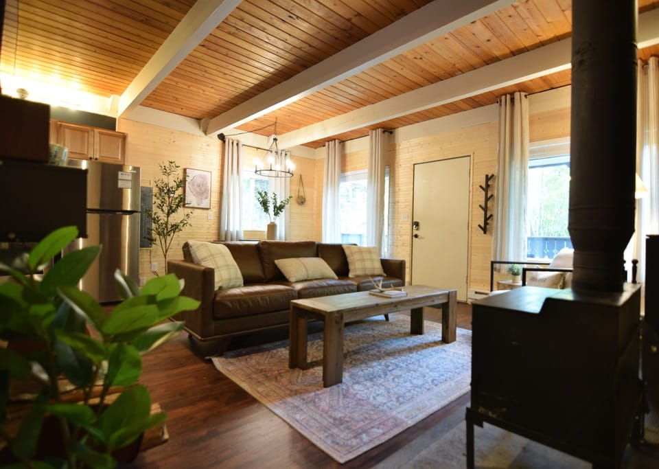 Relax and unwind in our snug living room, complete with a rustic wood-burning oven, after a thrilling day of hiking.