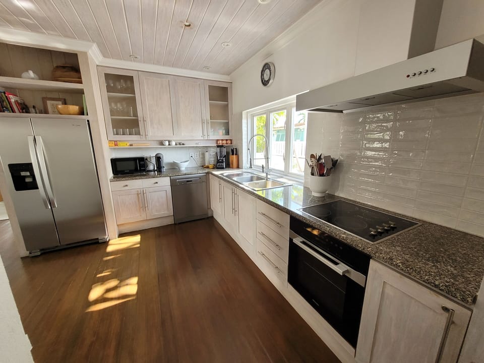 Open kitchen with new appliances and view of pool