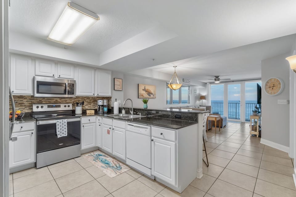 Fully stocked kitchen with view of ocean.