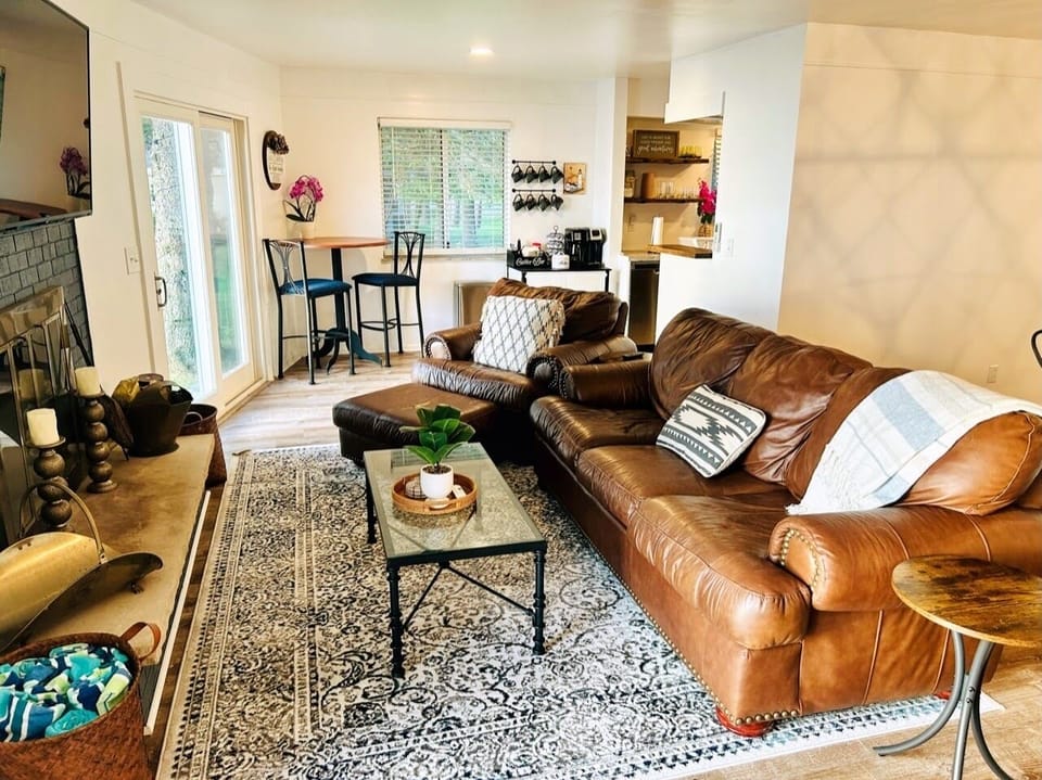 Comfy living room with lake views, wood burning fireplace, and TV. 