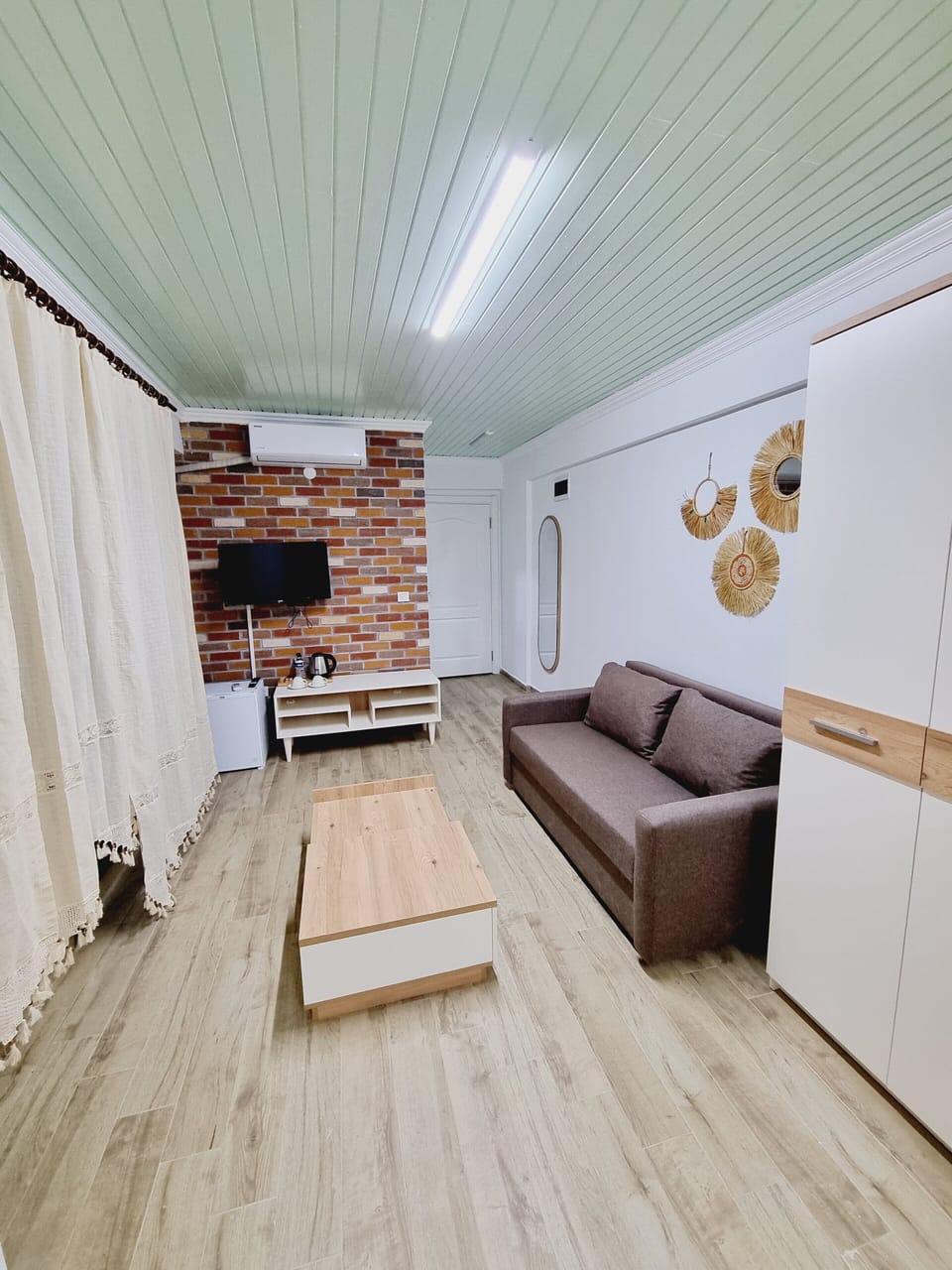 Design Apartment, 1 King Bed with Sofa bed, Courtyard View, Garden Area | Living area | 82-cm Smart TV with satellite channels, TV