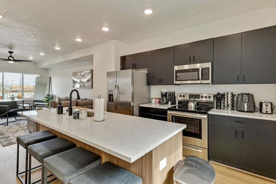 Fully equipped kitchen with stainless steel appliances, island seating, and all the essentials for cooking and dining 🍳🍷✨