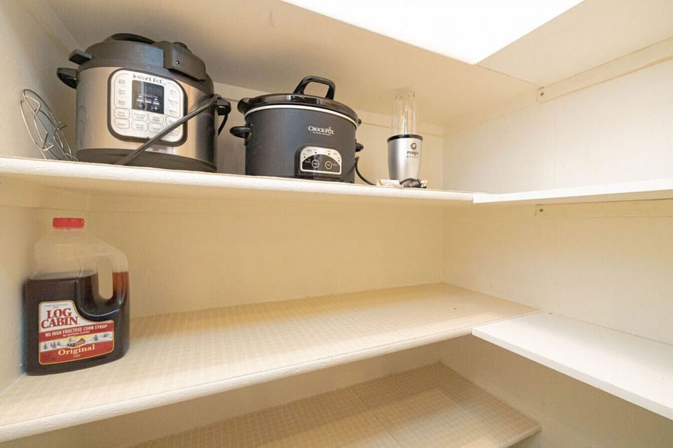 You can find the pressure cooker, Crockpot, blender and trash can in the pantry.