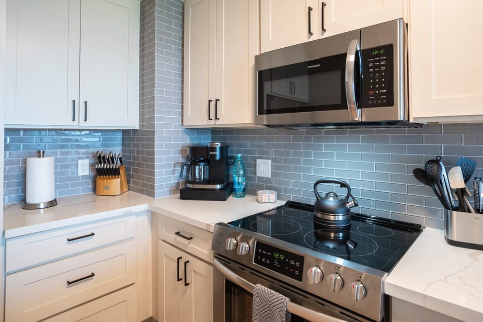 Luxury Condo | Private kitchen | Full-size fridge, microwave, oven, stovetop