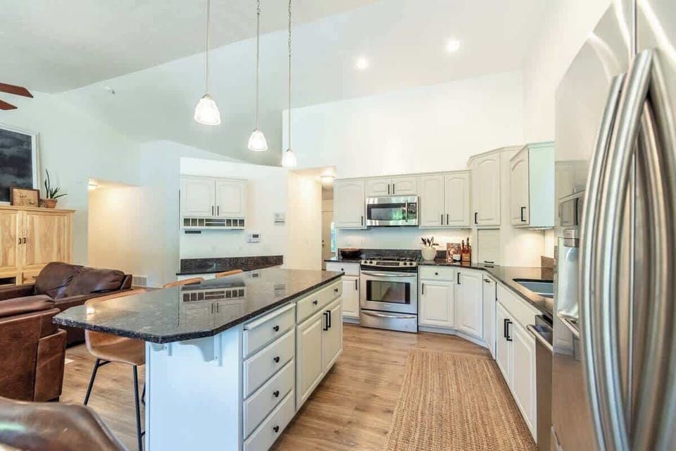 Fully stocked kitchen offering large island, granite counter tops, SS appliances, gas range.