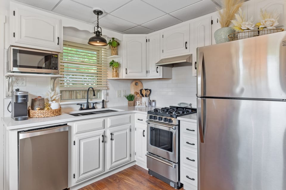 Kitchen with stainless steel appliances and quartz countertops 