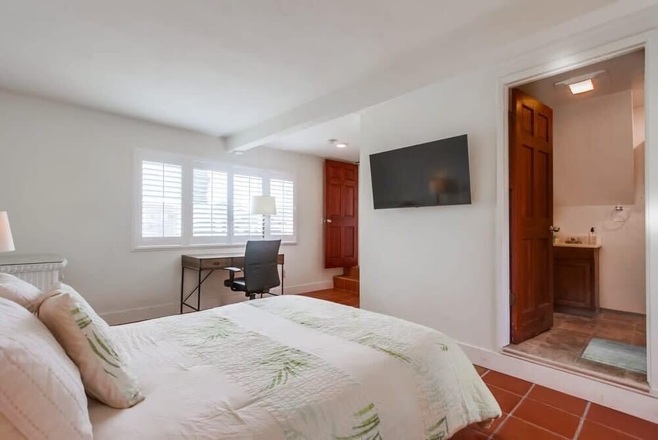 Master bedroom with desk, full bathroom and back patio