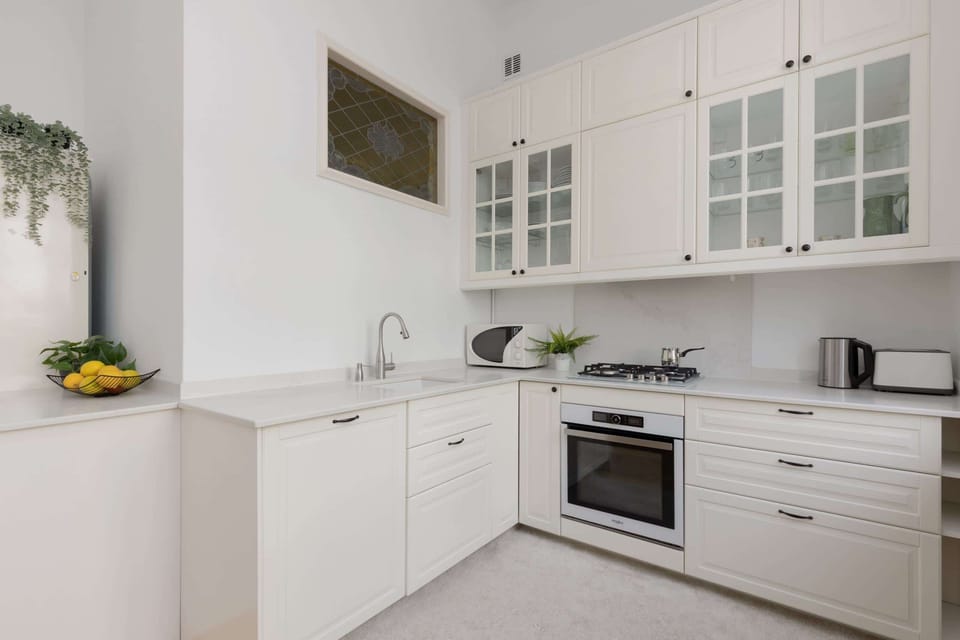 The kitchen's sleek design includes all necessary cookware and utensils. 