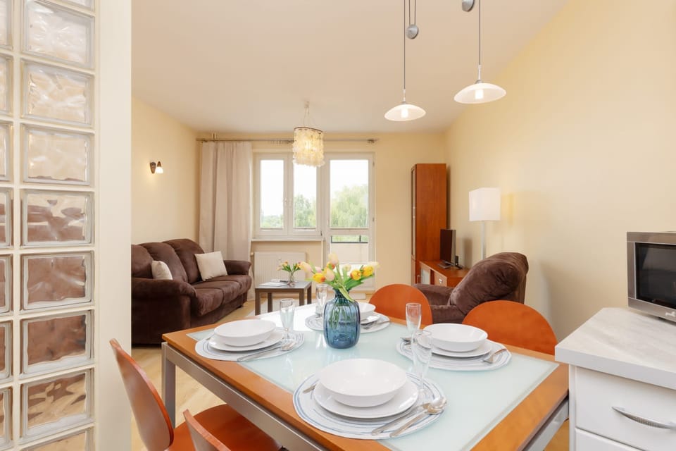 A wide-angle view of the dining and kitchen area, blending classic and modern elements in the design.
