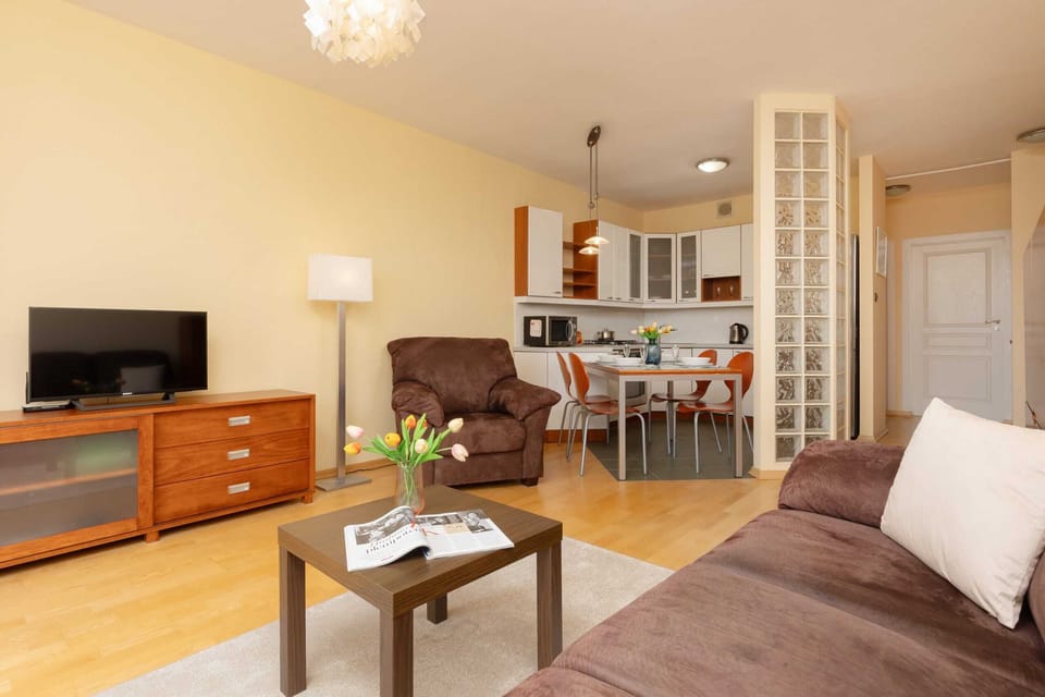 A combined view of the open-plan living, dining, and kitchen areas, emphasizing the functional layout.
