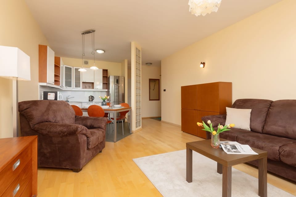 A bright and inviting living area with a mix of traditional and modern furnishings for a homely ambiance.
