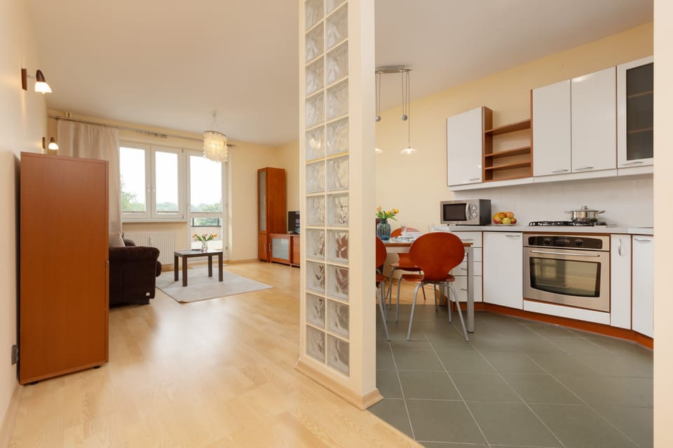 Another perspective of the open-plan space, showcasing its practicality and warm color palette.
