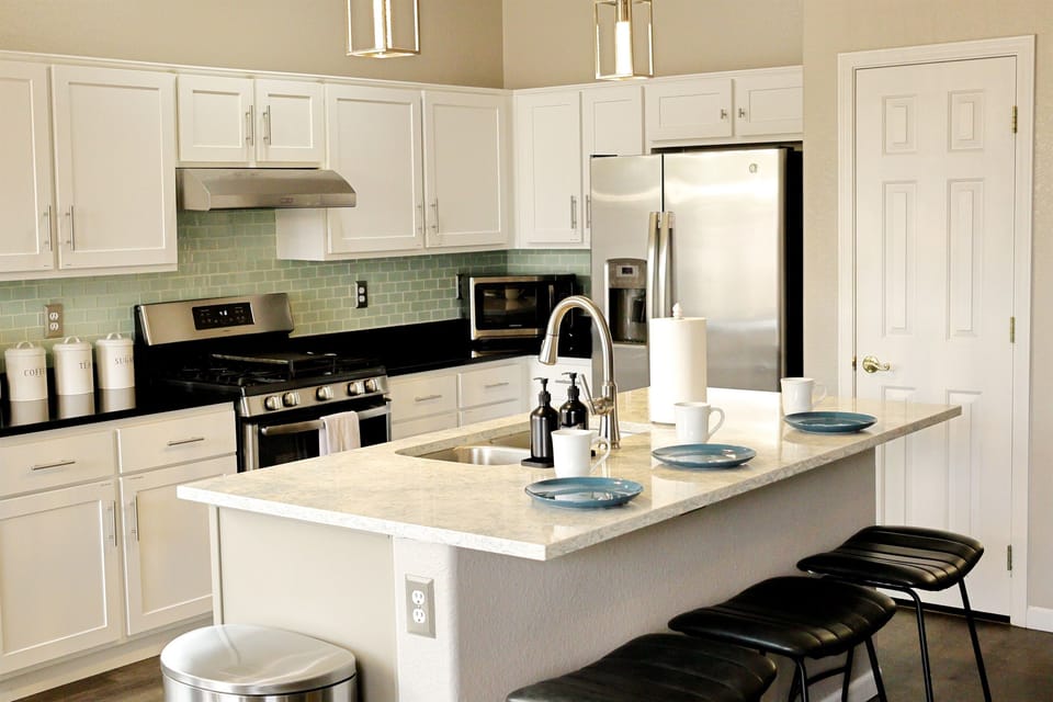 Bright, open kitchen with full amenities and modern lighting — ideal for family cooking and entertaining. 
