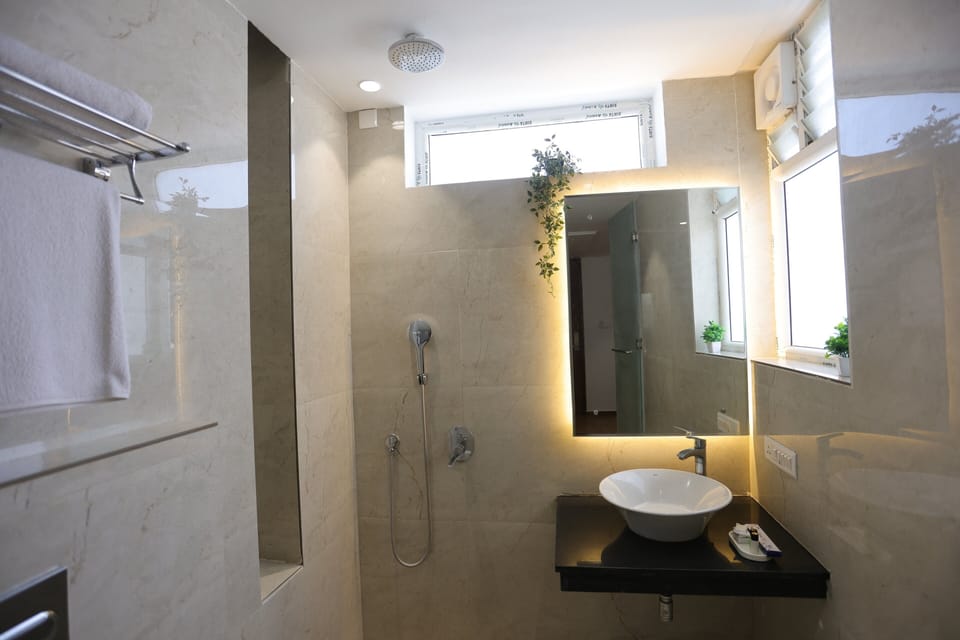 Studio++ | Bathroom | Shower, rainfall showerhead, hair dryer, towels