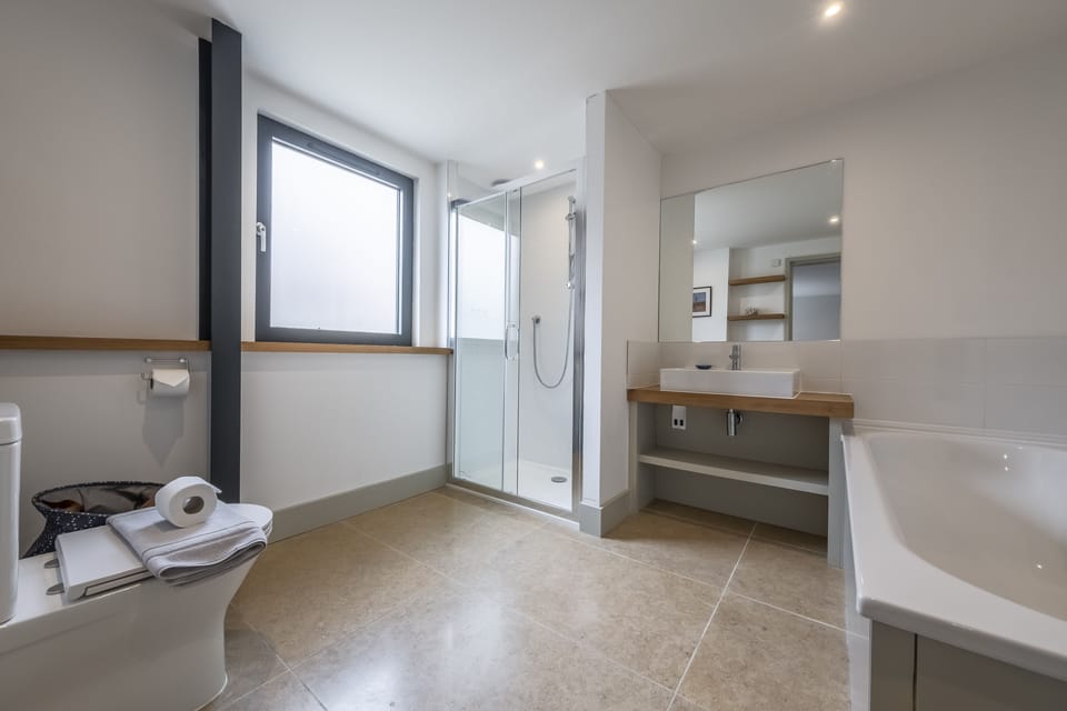 Ground floor: Bedroom two en-suite with walk-in shower and bath