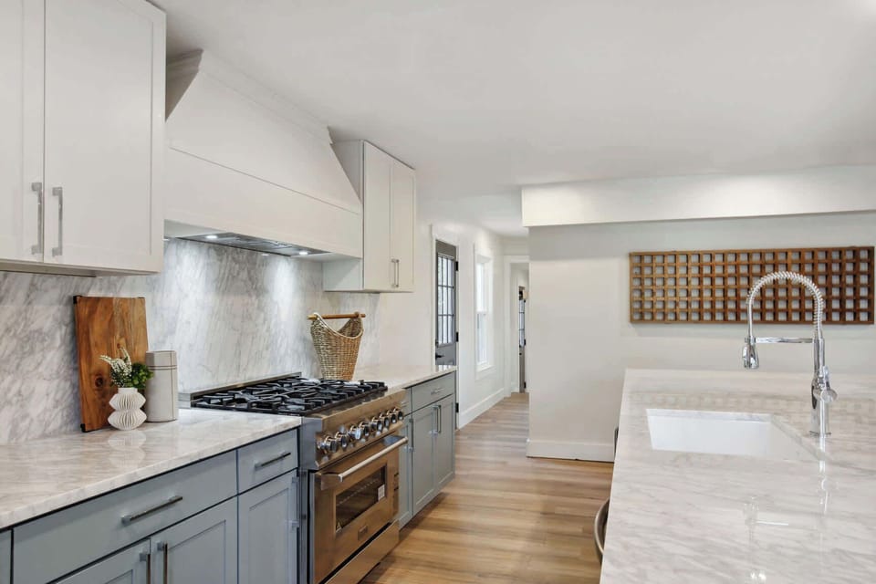 itchen | Fully Stocked Kitchen with Island and Bar Seating | First Floor