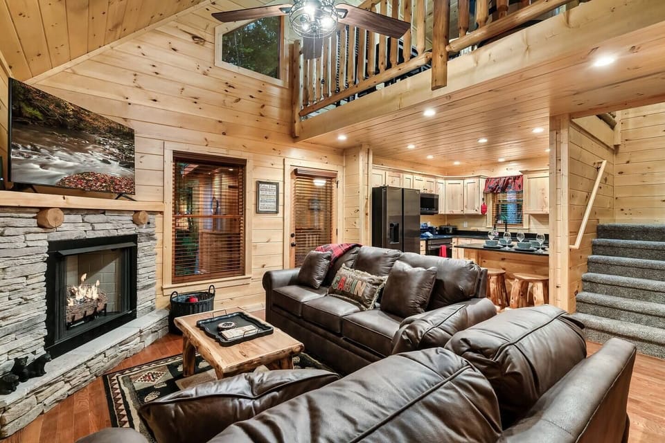 Family room with smartTV and fireplace adjacent to the kitchen and the screened porch.