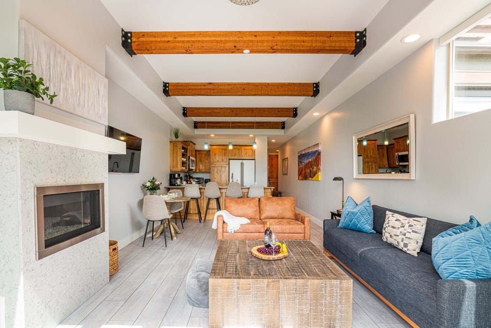 High beamed ceilings, gas fireplace, and Smart TV