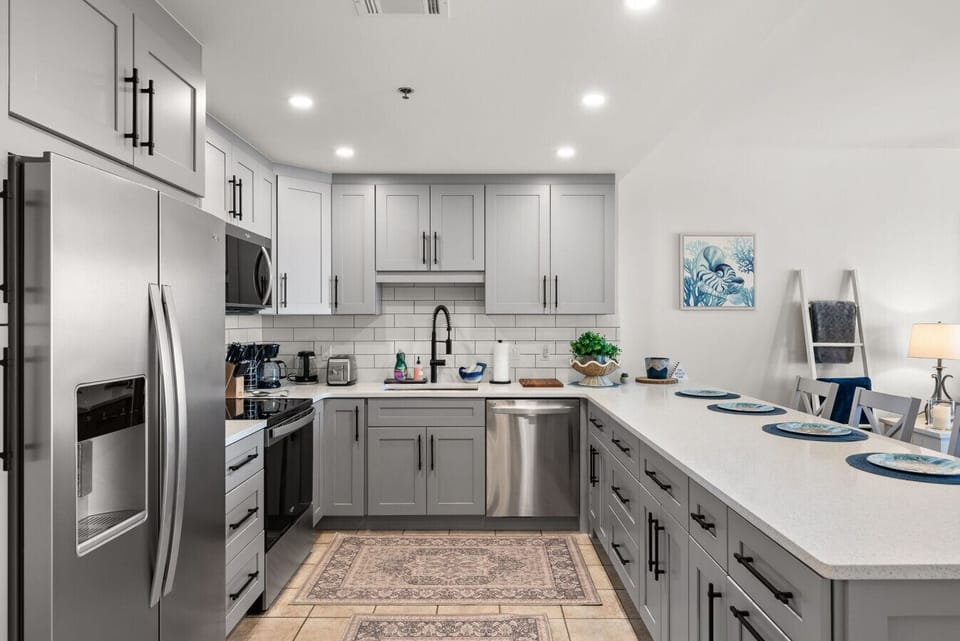 Fully updated kitchen features stainless-steel appliances, quartz countertops, and all the essentials for effortless vacation cooking.
