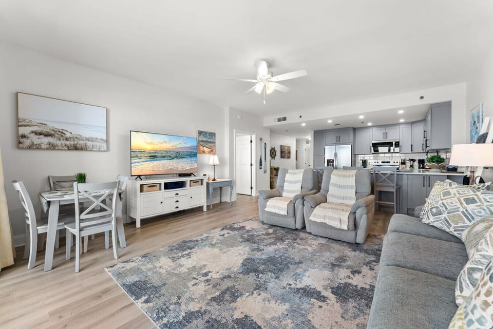 Spacious open living area features plush seating and seamless flow into the kitchen for easy vacation lounging.