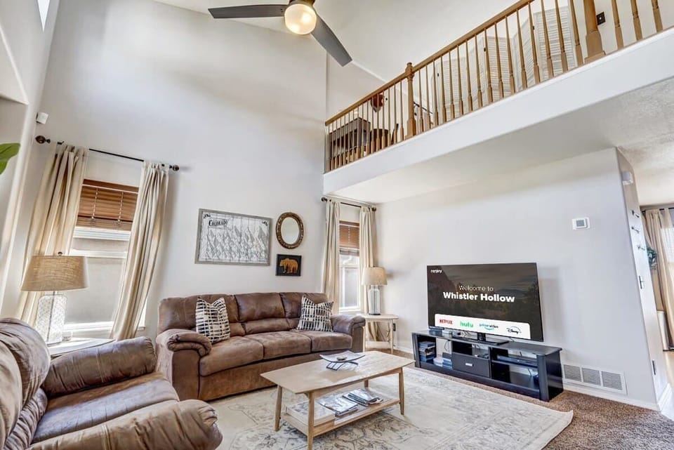 Our Living Room Boasts a Smart TV, Cozy Couches and Chairs, Warm Lamps, and Expansive Windows for Natural Light and Breathtaking Views.